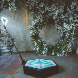 360 video booth with illuminated platform and triangular light