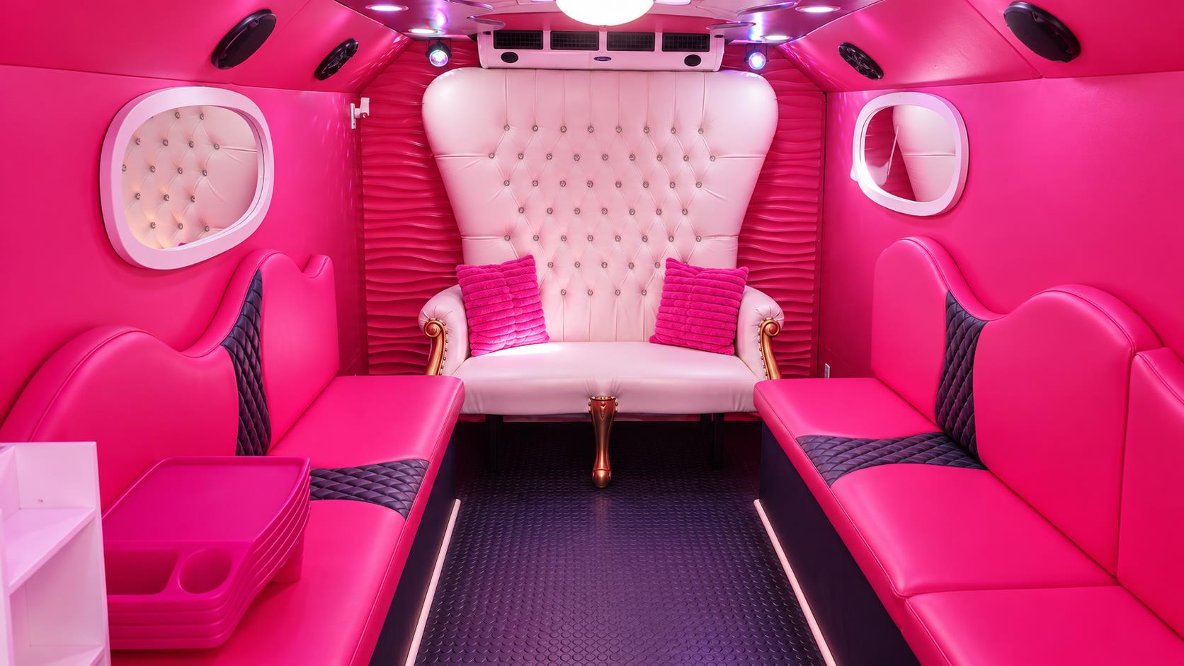glam interior with pink benches, dark quilted inserts and a white tufted throne